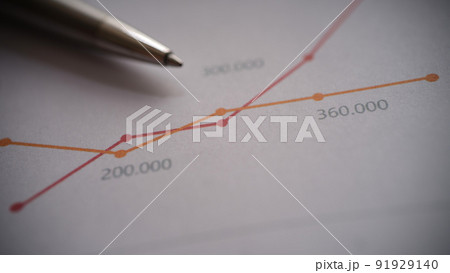 Metal pen on documents with colourful graphs with lines 91929140