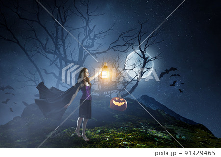 Beautiful young woman in witches hat and costume 91929465