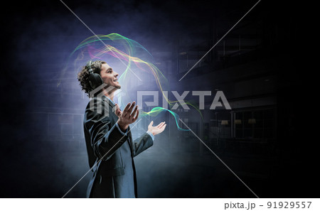 Young businessman with headphones . Mixed media 91929557