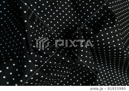 Black fabric with white dots. Crumpled or wavy fabric texture background. Abstract linen cloth soft waves. Natural yarn. Smooth elegant luxury cloth texture. Concept for banner or advertisement. Black fabric with white dots. Crumpled or wavy fabric texture background. Abstract linen cloth soft waves. Natural yarn. Smooth elegant luxury cloth texture. Concept for banner or advertisement. 91933980