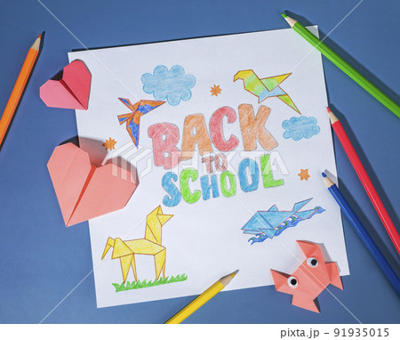 back to school children's drawing with colored pencils and origami. school supplies for back to school concept background back to school children's drawing with colored pencils and origami. school supplies for back to school concept background 91935015