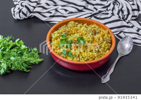 Pilaf with beef, carrots, onions, garlic, pepper and cumin. A traditional dish of Asian cuisine. Pilaf with beef, carrots, onions, garlic, pepper and cumin. A traditional dish of Asian cuisine. 91935341