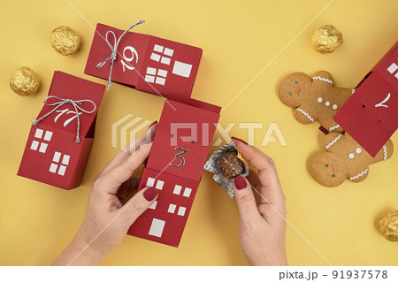homemade advent calendar made of cardboard boxes with gingerbread men and chocolates, Christmas waiting calendar homemade advent calendar made of cardboard boxes with gingerbread men and chocolates, Christmas waiting calendar 91937578