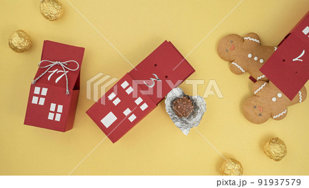 homemade advent calendar made of cardboard boxes with gingerbread men and chocolates, Christmas waiting calendar 91937579