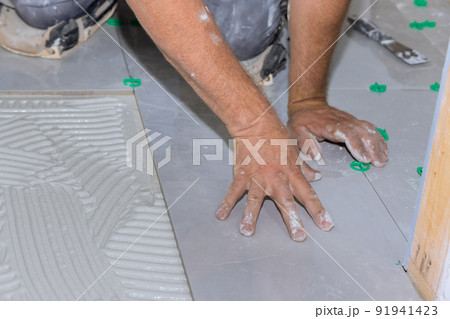 Installing ceramic floor tiles on an adhesive surface Installing ceramic floor tiles on an adhesive surface 91941423