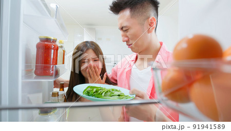 asian couple open refrigerator 91941589
