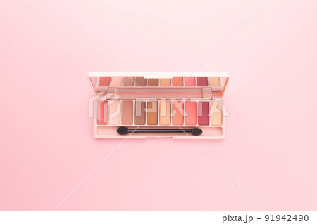 Top view of eye shadow make up palette on pink background. Beauty and cosmetic concept. Top view of eye shadow make up palette on pink background. Beauty and cosmetic concept. 91942490