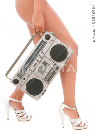 long woman legs with an old cassette 91943467