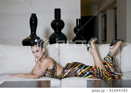 Young woman lying on sofa Young woman lying on sofa 91944785