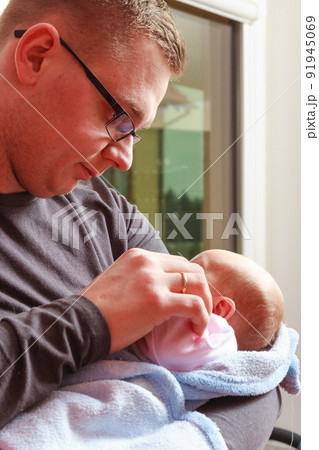 Father holding taking care of newborn baby Father holding taking care of newborn baby 91945069