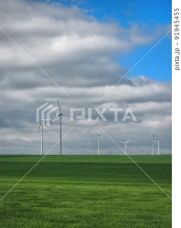 Eolian farm renewable energy in fresh green field against clear blue sky Eolian farm renewable energy in fresh green field against clear blue sky 91945455
