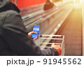 Covid-19 Health Passport in shopping center. Vaccinated man holding cell phone with covid 19 vaccination proof 91945562