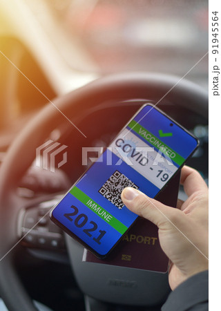 Covid-19 Health Passport. Vaccinated man holding cell phone with covid 19 vaccination proof Covid-19 Health Passport. Vaccinated man holding cell phone with covid 19 vaccination proof 91945564