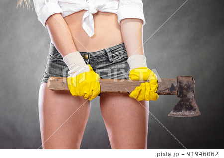Closeup of strong woman feminist with axe working. 91946062