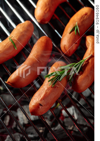 Grilled sausages with rosemary on a grill. Grilled sausages with rosemary on a grill. 91946160