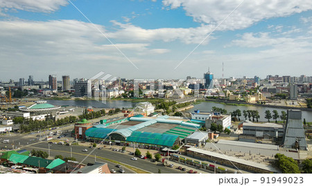 Panorama of a big city with many buildings and a river and a cloudy sky above it Panorama of a big city with many buildings and a river and a cloudy sky above it 91949023