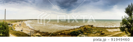 sea landscape with big stones in front and windmills farm on background, Azov sea, Ukraine 91949460