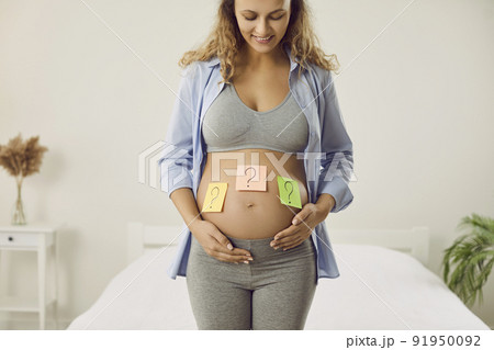Happy pregnant woman wonder about baby gender 91950092