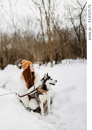 cheerful woman winter outdoors with a dog fun nature winter holidays 91950576