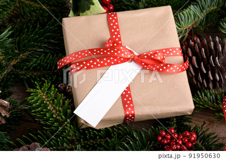 Christmas rectangle strip gift tag mockup with present box, product label mockup, with natural fir tree branch, name tag Christmas rectangle strip gift tag mockup with present box, product label mockup, with natural fir tree branch, name tag 91950630