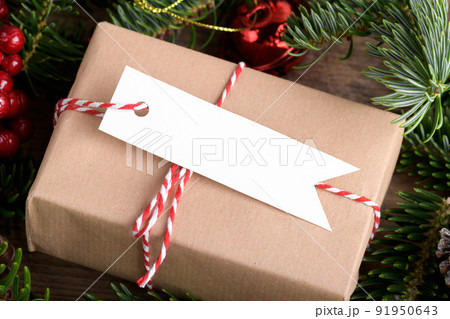 Christmas rectangle strip gift tag mockup with present box, product label mockup, with natural fir tree branch, name tag 91950643