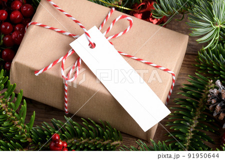 Christmas rectangle strip gift tag mockup with present box, product label mockup, with natural fir tree branch, name tag 91950644