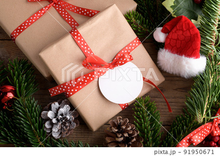 Blank round Christmas gift tag mockup with present box, product label mockup, with natural fir tree branch Blank round Christmas gift tag mockup with present box, product label mockup, with natural fir tree branch 91950671