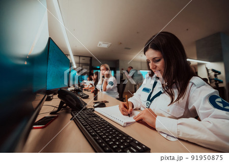 Group of female security operators working in a data system control room Technical Operators Working at workstation with multiple displays, security guards working on multiple monitors in surveillan Group of female security operators working in a data system control room Technical Operators Working at workstation with multiple displays, security guards working on multiple monitors in surveillan 91950875