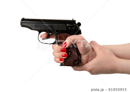 The woman is holding a gun in one hand while supporting her wrist with the other, aiming at the point of view. 91950955
