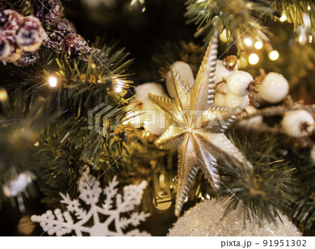 Christmas tree with shiny decorations. Fir tree decorated with light bulbs and star for New Year celebration. Christmas tree with shiny decorations. Fir tree decorated with light bulbs and star for New Year celebration. 91951302
