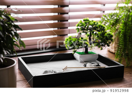 Beautiful miniature zen garden on wooden table 91952998