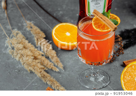 Warming winter cocktail with aperol. Hot aperol. Cocktail For New Years and Christmas. Christmas winter cocktail with aperol spritz martini pineapple juice and spices Warming winter cocktail with aperol. Hot aperol. Cocktail For New Years and Christmas. Christmas winter cocktail with aperol spritz martini pineapple juice and spices 91953046