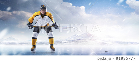 Professional hockey player. Sports emotions.Isolated on ice. Hockey player in the helmet and gloves on winter background 91955777