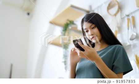 Happy young asian woman relaxing at home Happy young asian woman relaxing at home 91957835