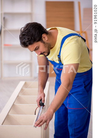 Young male carpenter working at home Young male carpenter working at home 91961020