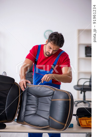 Young male repairman working at workshop Young male repairman working at workshop 91961234