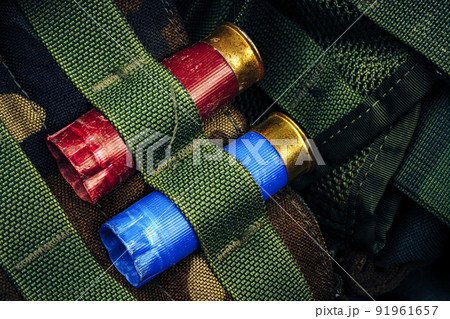 Two hunting cartridges in ammunition belt close up 91961657