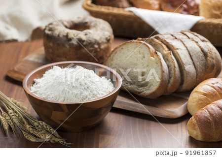 テーブルに並んだたくさんの種類のパンと小麦粉 91961857
