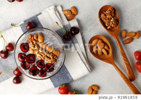 Chia pudding with cherry and nuts in glass bowl 91961859