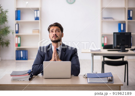 Young male employee working in the office Young male employee working in the office 91962189