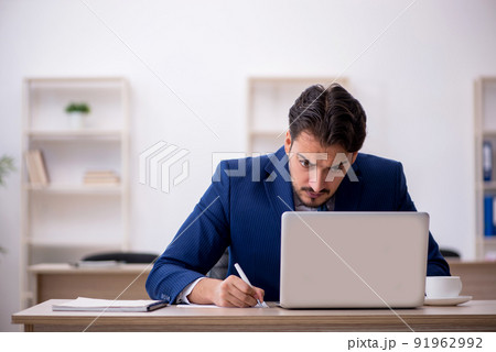 Young male employee working in the office Young male employee working in the office 91962992