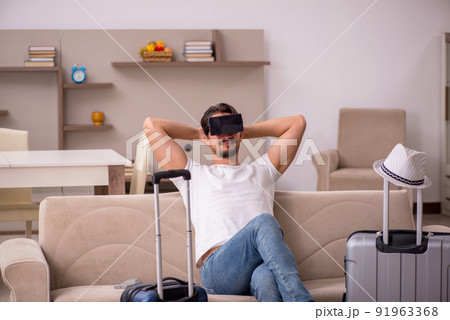 Young man preparing for trip at home Young man preparing for trip at home 91963368