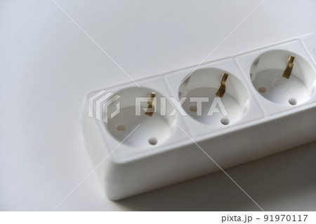 White electrical extension cord mains filter with sockets on a white background 91970117