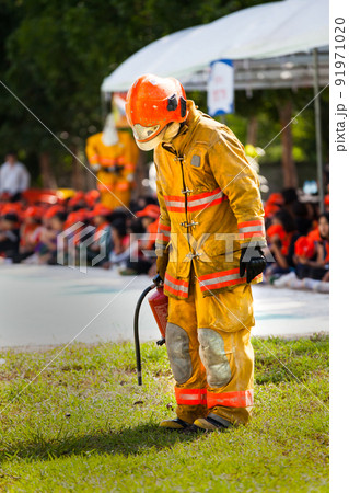 Firefighter with fire and suit for protect fire fighter for training firefighters. Firefighter with fire and suit for protect fire fighter for training firefighters. 91971020