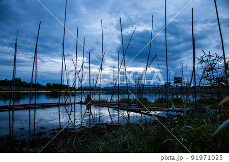Traditional fishing tool or bamboo fish trap on sunset light, landscape silhouette. Traditional fishing tool or bamboo fish trap on sunset light, landscape silhouette. 91971025