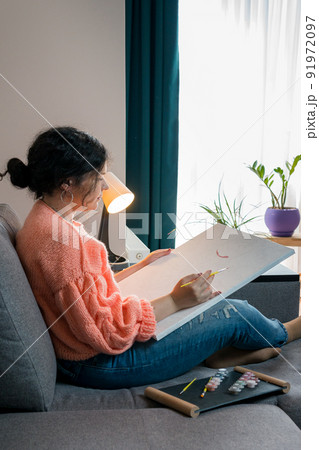 The adult woman painting by numbers, pastel colors, drawing on canvas The adult woman painting by numbers, pastel colors, drawing on canvas 91972097