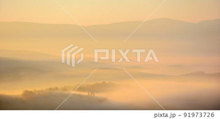 carpathian countryside scenery at sunrise. fog rolling among the hills down in to the rural valley in autumn. wonderful mountain landscape glowing in morning light carpathian countryside scenery at sunrise. fog rolling among the hills down in to the rural valley in autumn. wonderful mountain landscape glowing in morning light 91973726