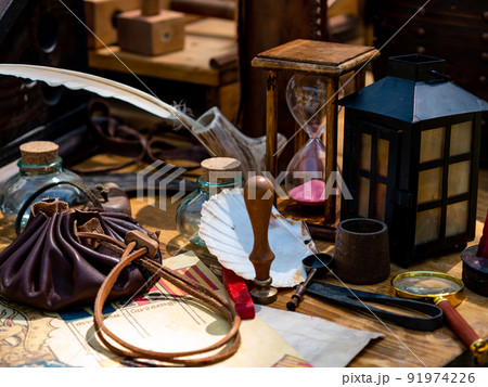 scribe's table with goose feather pen, hourglass scribe's table with goose feather pen, hourglass 91974226