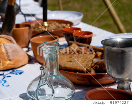 table set for outdoor medieval dining in a park during a festival 91974227