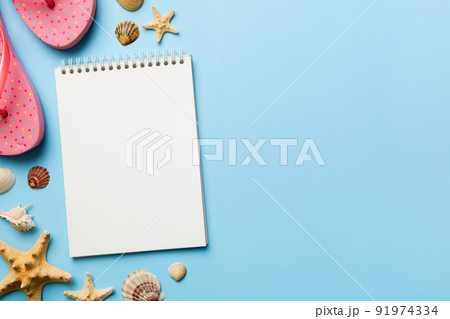 Blank writing book with summer beach accessories on background, copy space. Flat lay with copy space 91974334